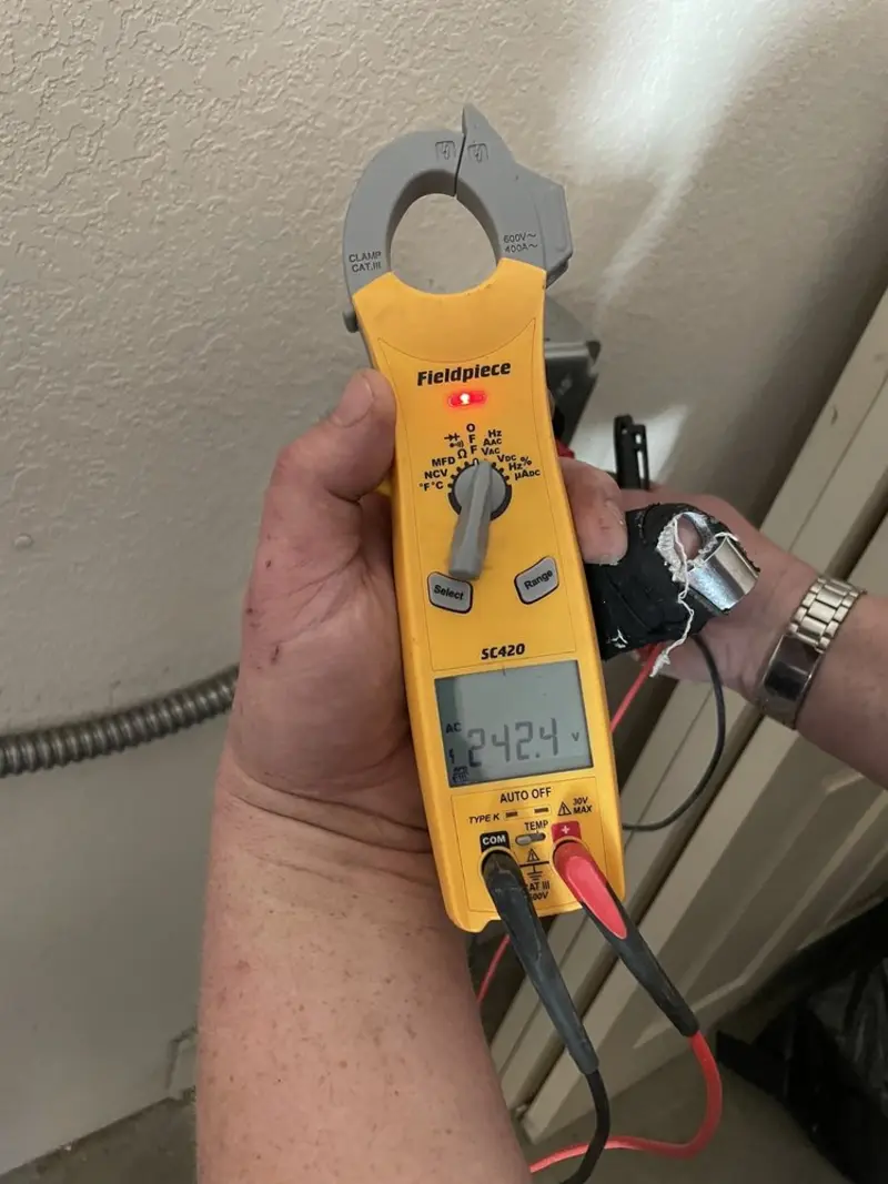 Voltage testing with clamp meter during Outlet Installation in Zuni Pueblo